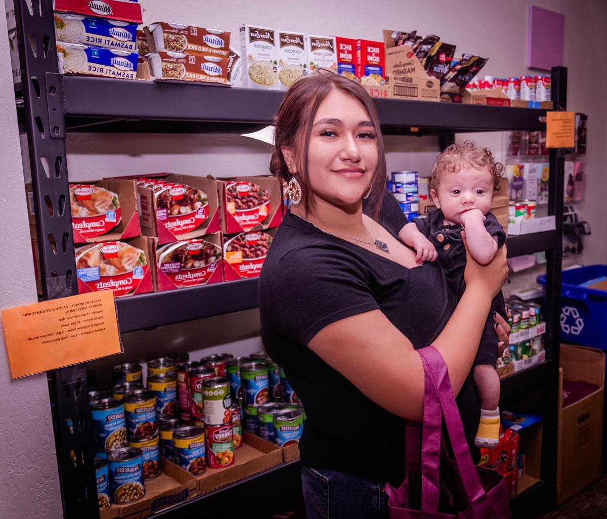 student mother holding baby